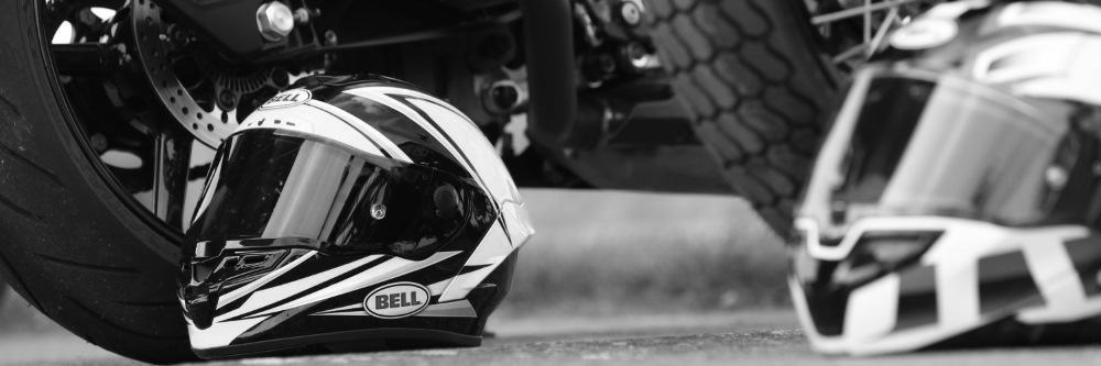 Bell Motorcycle Helmet On Road Next To Bike