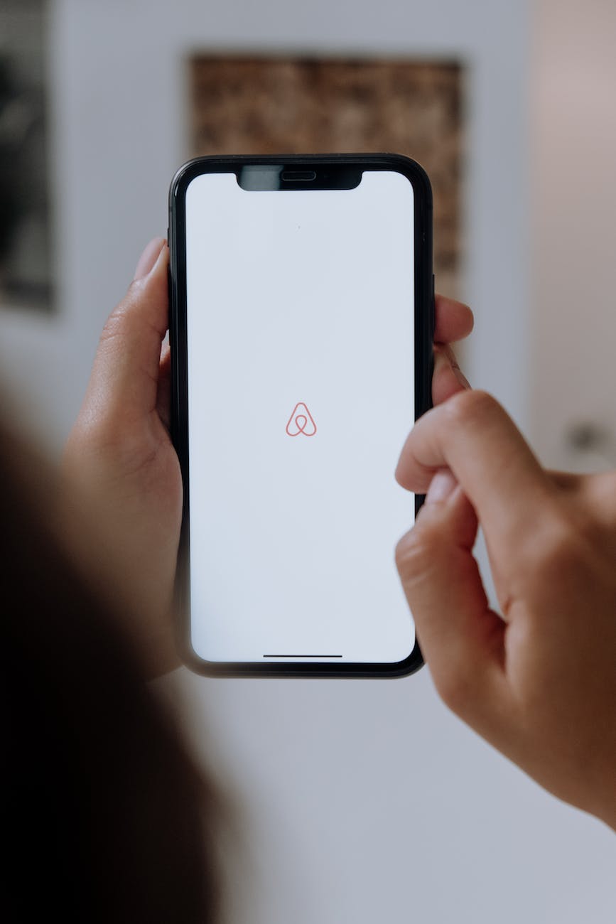 a person using their phone to look at properties to stay in on the Airbnb app