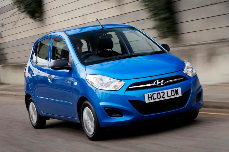 a blue Hyundai i10 Active Model car being driven along a road 