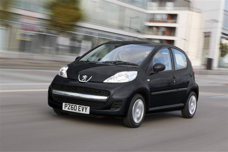 a black Peugeot 107 being driven along a city street